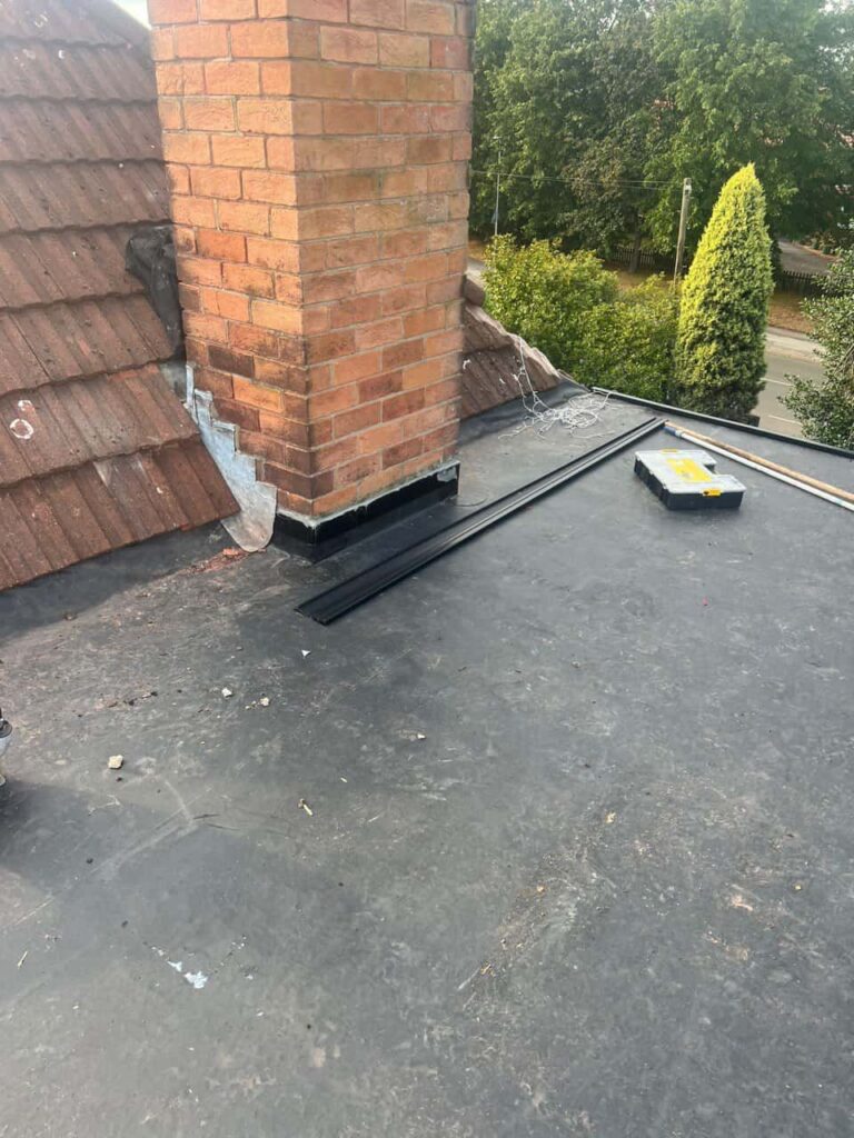 This is a photo of a flat roof which has just been repaired, there is also a chimney stack and some leadwork has also been dressed. Works carried out by Hedge End Roofing Repairs