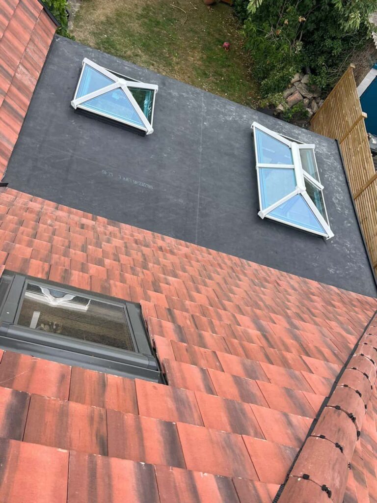 This is a photo taken from the roof ridge looking down a tiled pitched roof on to a flat roof. Works carried out by Hedge End Roofing Repairs